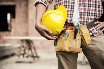 Tradie holding a hard hat