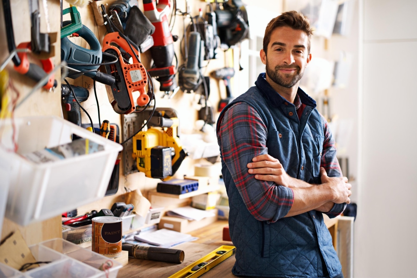 Tradesman in a workshop full of tools