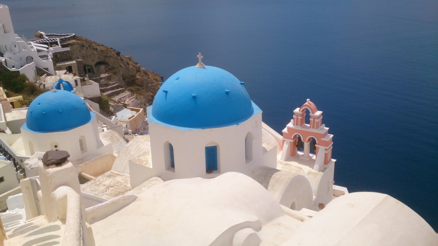 classic Greek view with white walls and blue roofs