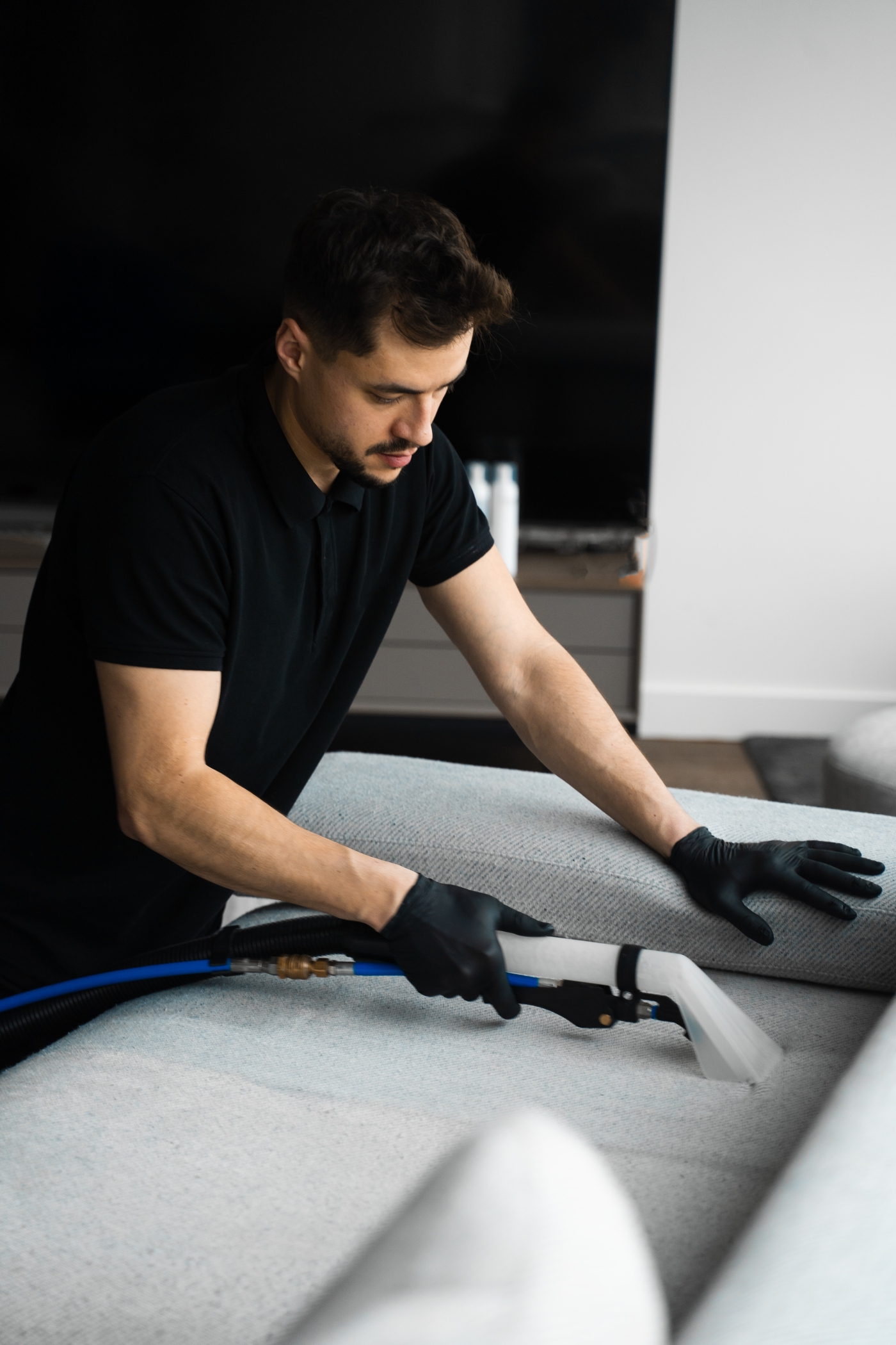 professional cleaner cleaning a sofa